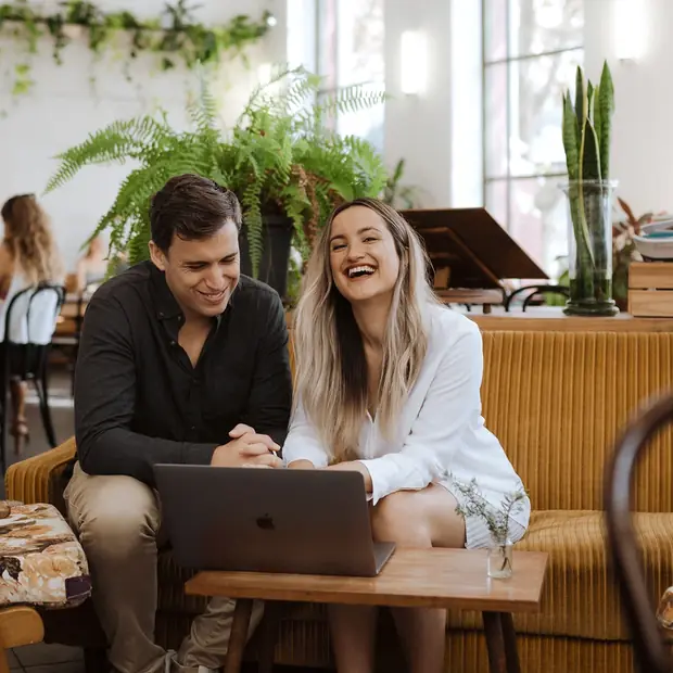 Matt and Sarah working at a cafe table